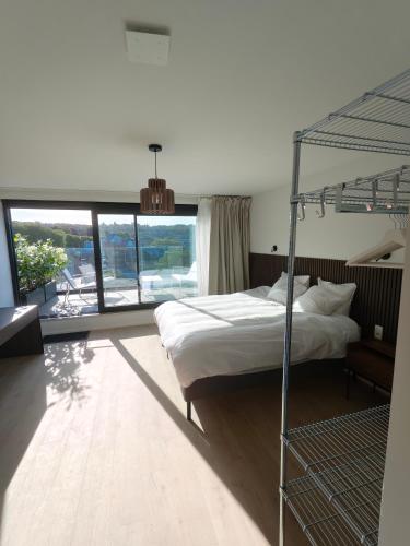a bedroom with a bunk bed and a large window at Chez EdGare in Liège