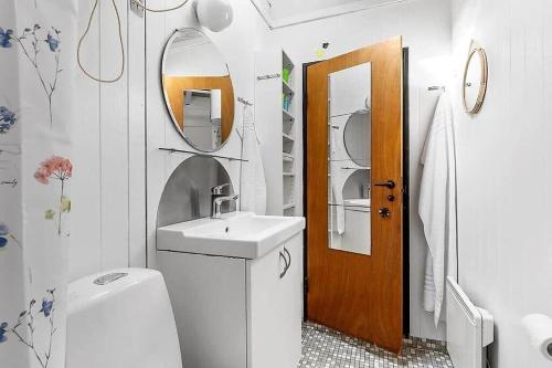 a bathroom with a sink and a toilet and a mirror at 1007-N-Hundested-Humlehaven-5 in Hundested