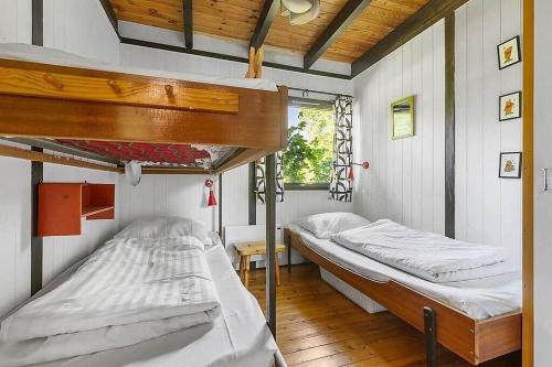 a bedroom with two bunk beds and a window at 1007-N-Hundested-Humlehaven-5 in Hundested