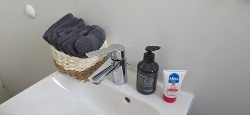 a bathroom sink with a basket on top of it at Cozy city appartement in Forchheim