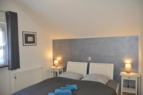 a bedroom with a bed with blue pillows on it at Ferienwohnung Wildgatter in Grafenwiesen
