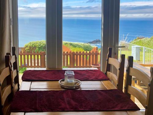 a table with a candle on a table on a porch at Ruach in Gardenstown