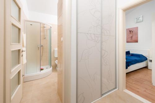 a bathroom with a shower with a glass door at Villa Dea in Vučevica