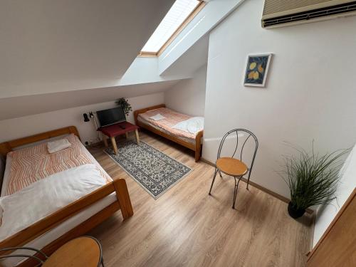 a bedroom with two beds and a table and a chair at Motel S7 in Goszczyn