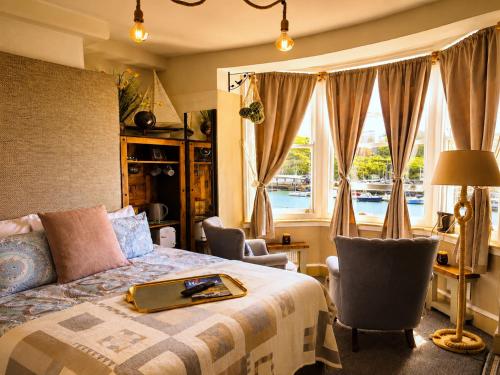 a bedroom with a bed with a laptop on it at The Ocean Guest House in Weymouth