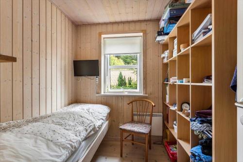 a small bedroom with a bed and a window at FY166-Middelfart-Skrillinge-Strand-100 in Middelfart