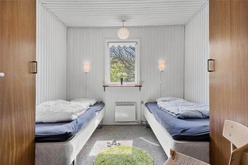 a small room with two beds and a window at C11306-Tarm-Hjortevej-10 in Tarm