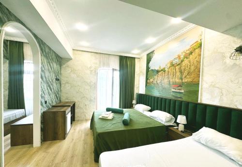 a bedroom with two beds and a painting on the wall at 7 Baits Hotel in Tbilisi City