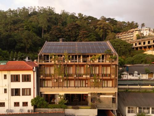 a building with solar panels on its roof at Lake Avenue Hotel Kandy in Kandy