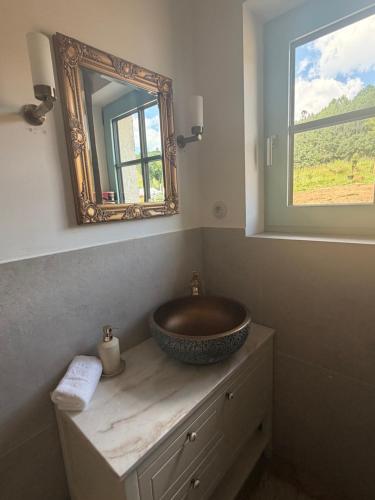 a bathroom with a bowl sink and a mirror at Farma HUGÁNIKOVO - families, pets & spa relaxation in Brezno