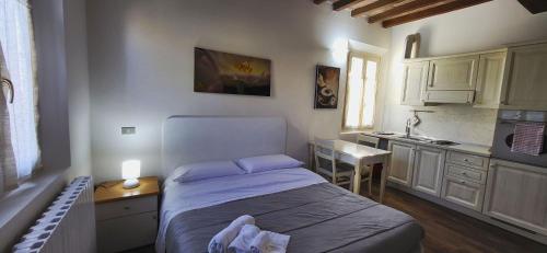 a small bedroom with a bed and a kitchen at Residence Villa Stufler in Modena