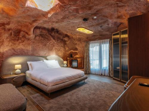 a bedroom with a bed in a rock wall at Arborea Hotel in Trabzon