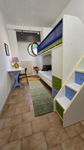 a small room with a bunk bed and a desk at Home Garden in Roseto degli Abruzzi
