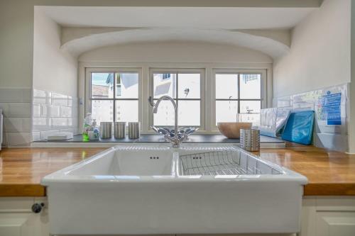 a kitchen with a large white sink in a kitchen at Hafod in Tenby