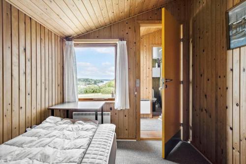 a bedroom with a bed and a desk and a window at FY269-Faaborg-Lille-Stege-2 in Faaborg