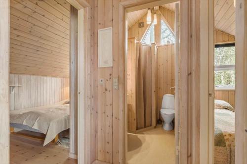 a bedroom with a bed and a toilet in a room at 8923-Allingabro-Poppelvej-17 in Allingåbro