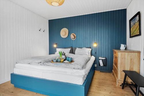 a blue and white bedroom with a large bed at 30116-Odder-P-Baatrupsvej-47 in Odder