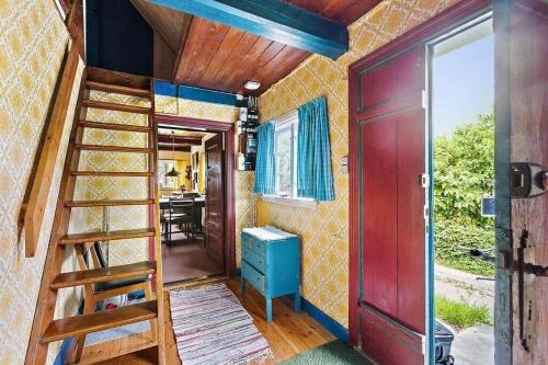 a room with a staircase and a red door at 1102-N-Hundested-Skansevej-45 in Hundested
