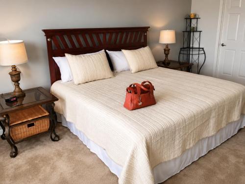a red purse sitting on top of a bed at 5BR Florida villa with private pool in Davenport