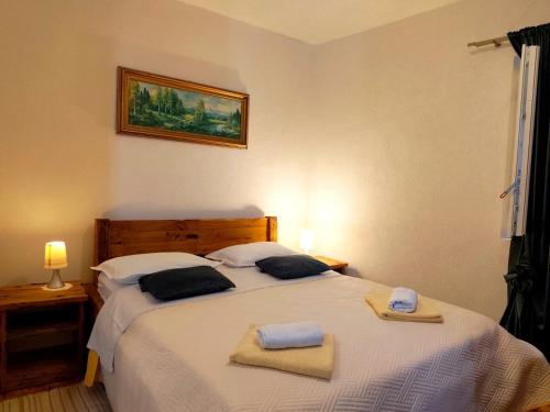 a bedroom with a bed with two towels on it at Apartment Lore in Primošten