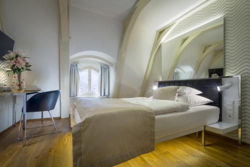a bedroom with a large bed with a large mirror at Golden Star in Prague