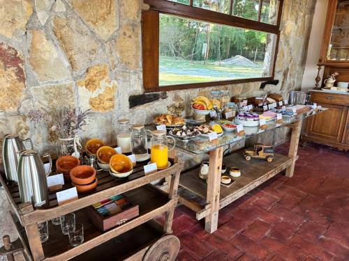 a breakfast table with food on it in a room at Casa Pradera - Hotel Serrano in Sierra de los Padres