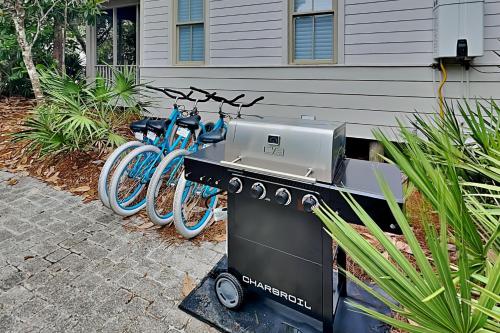 a grill and a bike parked next to a house at Sand Piper in Seacrest