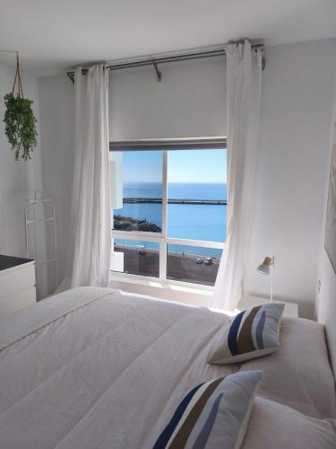 a bedroom with a bed with a view of the ocean at Casa Miramar in Gran Tarajal