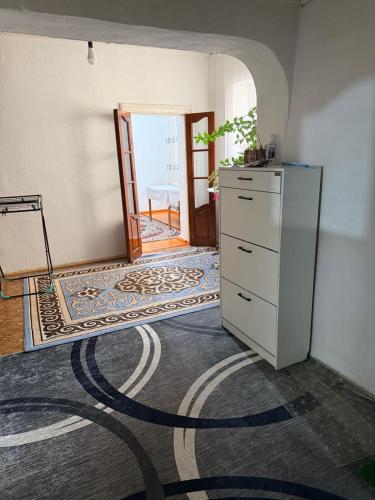 a room with a dresser and a door with a carpet at Nur-Nomad in Balykchy