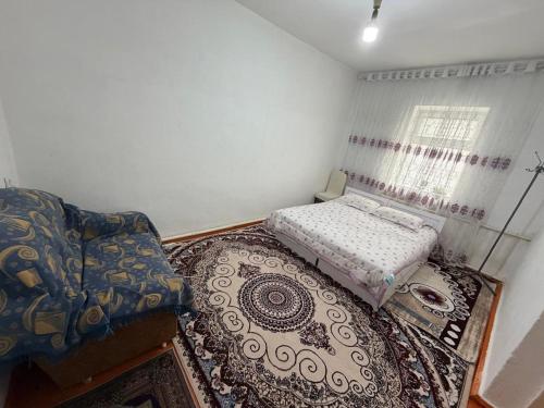 a small room with a bed and a couch at Nur-Nomad in Balykchy