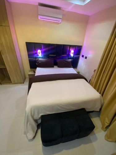 two beds in a room with purple lights at Chase hotels in Ibadan