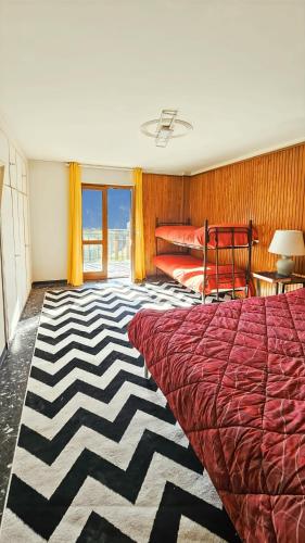 a bedroom with a large bed and a bed sqor at Limone Piemonte Kids Friendly in Limone Piemonte