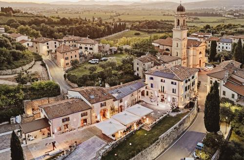 an aerial view of a town with a clock tower at Castrum Wine Relais - Albergo Diffuso in San Pietro in Cariano