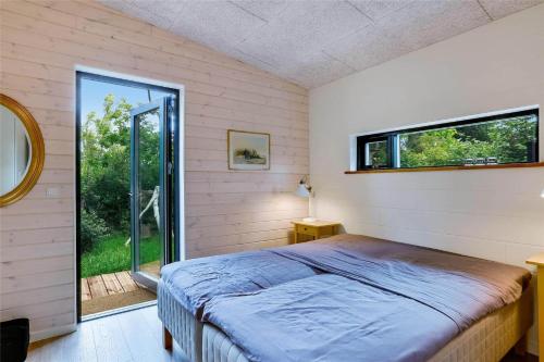 a bedroom with a bed and a large window at 30159-Odder-Thorasvej-24 in Odder