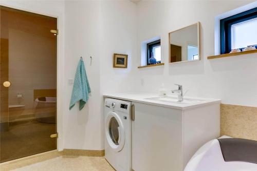 a bathroom with a washing machine and a sink at 30159-Odder-Thorasvej-24 in Odder