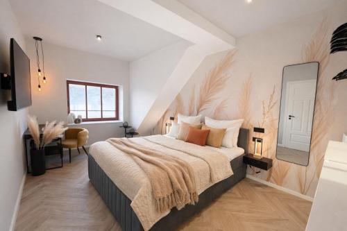 a bedroom with a bed and a table and a mirror at The Summit Rooftop I Meissen in Meißen