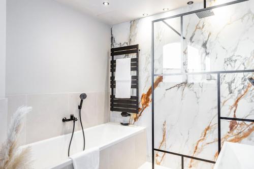 a bathroom with a shower and a bathtub at The Summit Rooftop I Meissen in Meißen