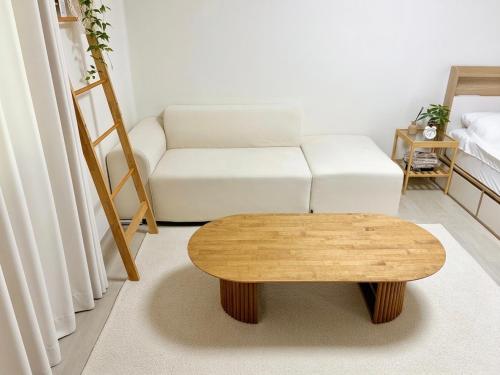 a living room with a white couch and a coffee table at Stay Joy in Suwon