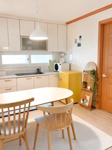 a kitchen with a table and two chairs at Stay Joy in Suwon