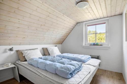 a large bed in a room with a wooden ceiling at 1126-Ringkobing-Frans-Julius-Vej-44 in Klegod