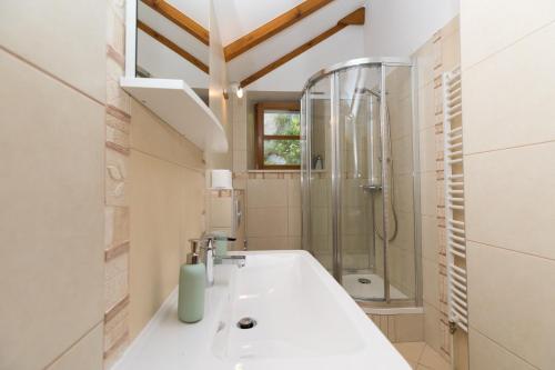 a bathroom with a sink and a shower at Holiday Homes Baučić in Omiš