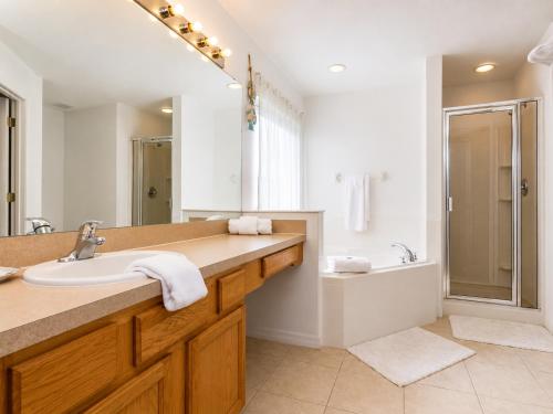 a bathroom with a sink and a shower and a tub at 5BR Florida villa with private pool in Davenport