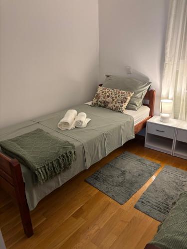 a bedroom with a bed with two towels on it at Adria in Brodarica
