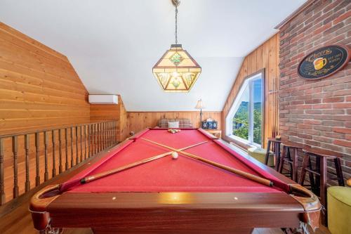 a pool table in a room with a ping pong ball at Spa Pool table Mountain - Chalet Avalanche in Saint-Philémon