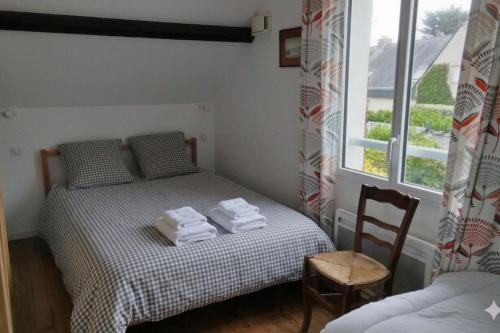 a bedroom with a bed with towels on it at Seaside house with cliff views in Piriac-sur-Mer