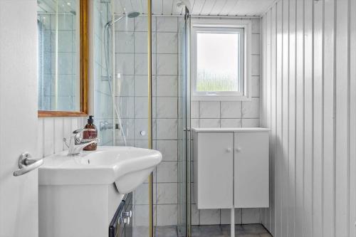 a white bathroom with a sink and a shower at LF212-Vestervig-Ingersvej-12 in Vestervig