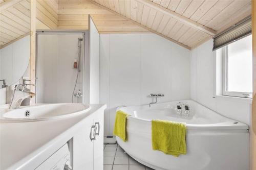a white bathroom with a tub and a sink at 30510-Odder-Elmegaardsvej-8 in Odder