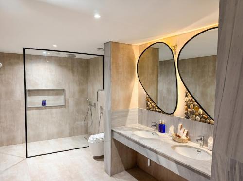 a bathroom with two sinks and a shower at FortuNorth in Skardu