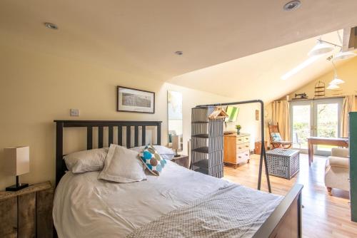 a bedroom with a bed and a living room at The Forge, Snitterton near Matlock in Moffat