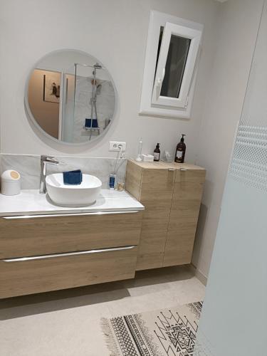 a bathroom with a sink and a mirror at Chambre des Iris in Graveson